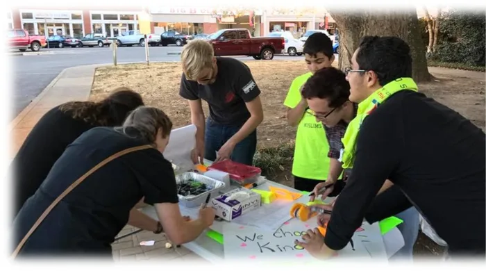 MMY volunteers packing supplies at an outdoor table