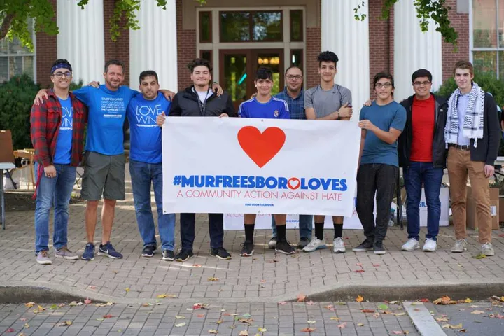MMY volunteers holding a #MurfreesboroLoves banner in downtown Murfreesboro