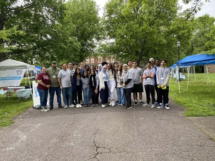 MMY youth and volunteers gathered outdoors at a community event